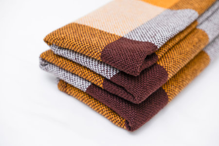 Brown plaid scarf on a light background.の写真素材