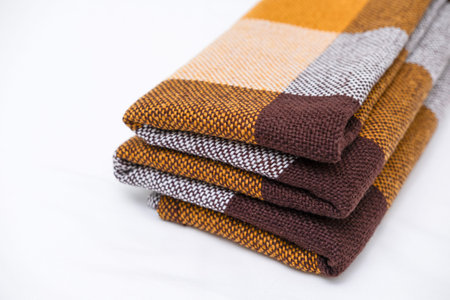 Brown plaid scarf on a light background.の写真素材