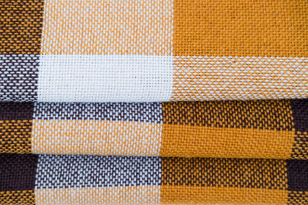 Brown plaid scarf on a light background.の写真素材