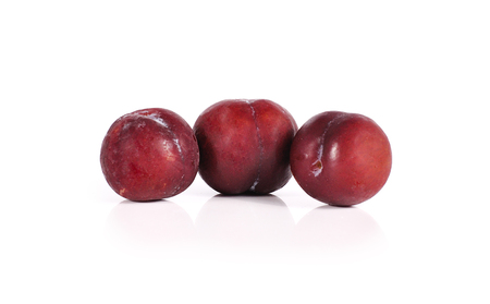 Plums close up isolated on white backgroundの写真素材