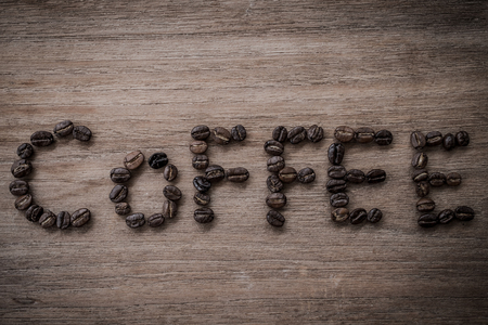 coffee beans isolated on wood backgroundの写真素材
