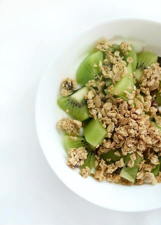 Granola yogurt kiwi mix in a bowl on backgroundの写真素材