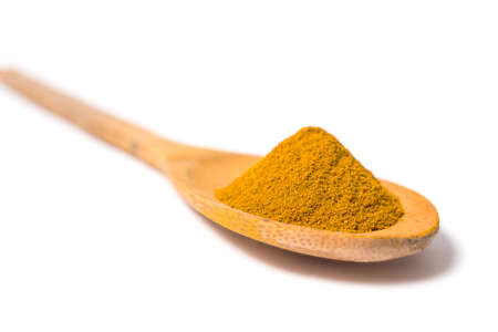 Milled curcuma on wooden spoonの写真素材