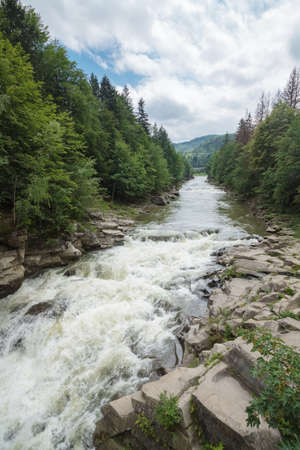 Powerful mountain river washed rocks in the woods. Yaremche. Carpathians. Ukraine.の写真素材
