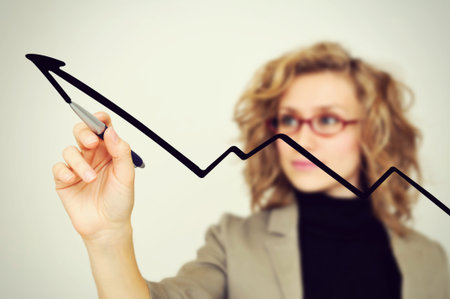 businesswoman drawing graph with penの写真素材