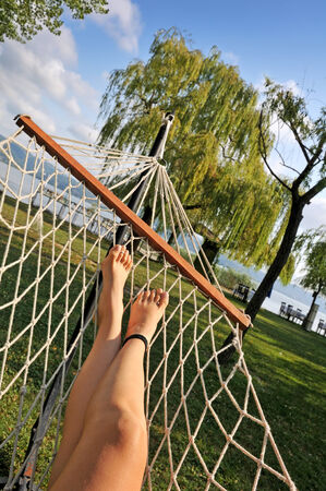 Woman resting in a hammock on a beach in the countryside.の写真素材