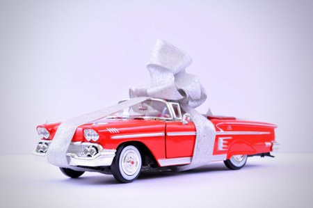 A ribbon wrapped undefinable model car as a gift.