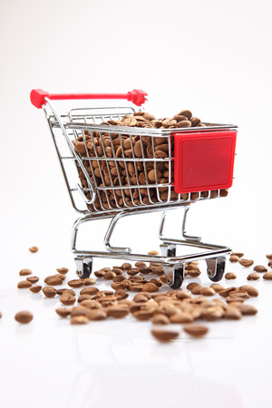 coffee in small shopping cart on the white background. Isolated on whiteの写真素材