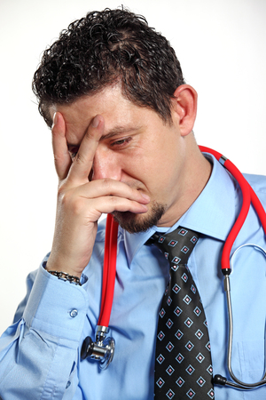 Sad and unhappy Doctor on the white backgroundの写真素材