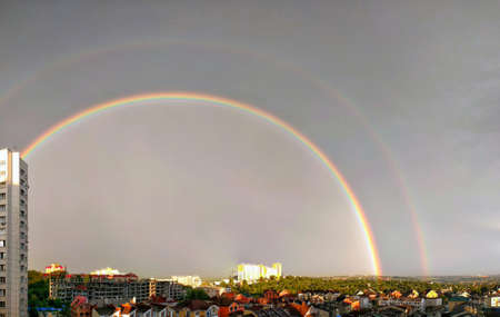 Urban suburb landscape with double rainbowのeditorial素材