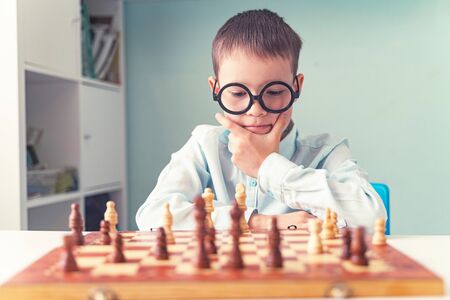little boy plays chess on self-isolationの写真素材