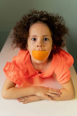 beautiful curly girl with orange smilingの写真素材
