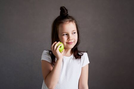 Beautiful funny girl with green apples. Proper nutrition is healthの写真素材
