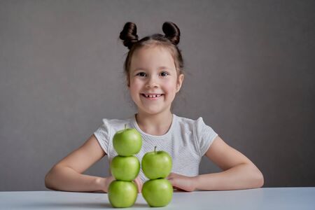 Beautiful funny girl with green apples. Proper nutrition is healthの写真素材