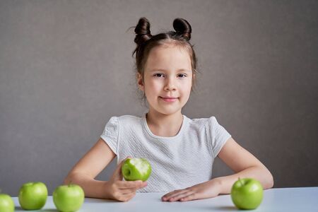 Beautiful funny girl with green apples. Proper nutrition is healthの写真素材
