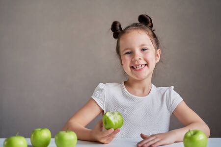 Beautiful funny girl with green apples. Proper nutrition is healthの写真素材