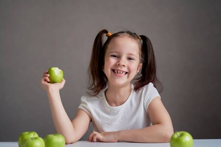 Beautiful funny girl with green apples. Proper nutrition is healthの写真素材