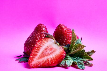 delicious juicy strawberries on a pink background.の写真素材