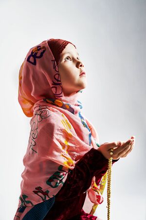 a young Muslim girl does namaz and prays to Allah. Ramadan fast. Ramadan Bayramの写真素材