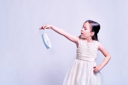 a beautiful girl in a beautiful dress waited for the end of the coronovirus epidemic.の写真素材
