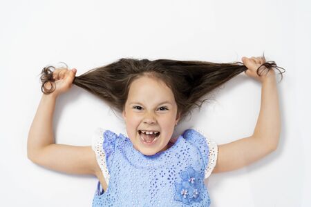 a beautiful girl lies on her back and pulls her hair to the side. the view from the top.の写真素材