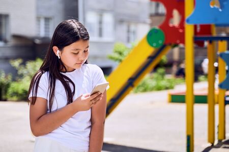 beautiful Asian girl with phone on the street.の写真素材