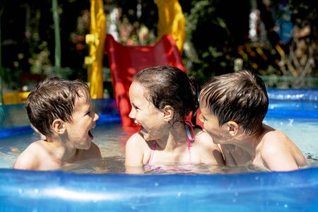 happy healthy children swim in the pool in summer and laugh.の写真素材