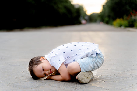 a funny little boy is lying on the floor.