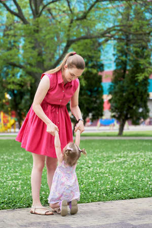 a small child is naughty on a walk with his mother.の写真素材
