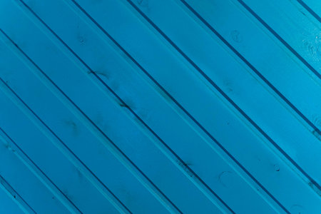 the surface of the wooden slats is painted blue.