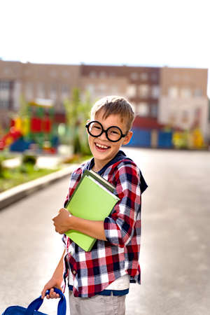 A small child with a school bag during the flash goes to school . First day of schoolの写真素材