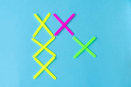 figures from counting sticks in the form of crosses on a blue backgroundの写真素材