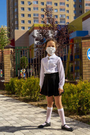 A little schoolgirl came to school to study in a medical mask.の写真素材