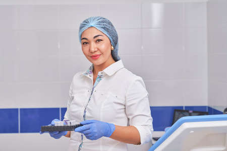 Asian female gynecologist in a white coat with tests.の写真素材