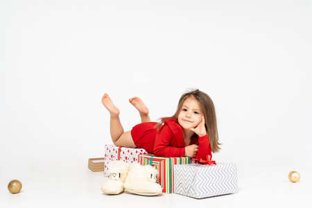 new year's picture: a little girl lies on the gifts that Santa Claus brought her.の写真素材