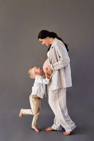 beautiful pregnant girl and her son in beautiful clothesの写真素材