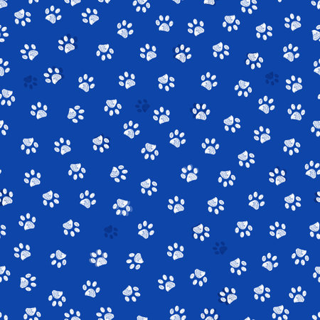 Blue background with white paw prints seamless fabric patternの写真素材