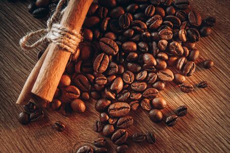 Coffee beans cinnamon sticks. Whole grains with aromatic spices, roasted coffee, blur.の写真素材