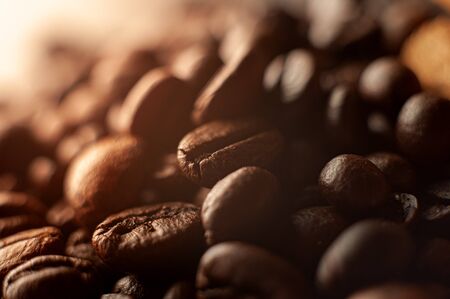 Coffee beans on the table fried with steam and hot close-upの写真素材