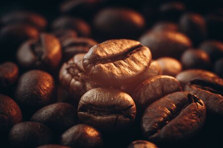 Coffee beans on the table fried with steam and hot close-upの写真素材