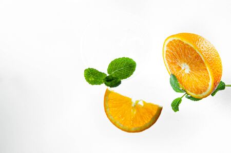 Fresh lemonade with mint, orange and ice in glass jar on the light background. Summer cold drink and cocktail. Top view and close-upの写真素材