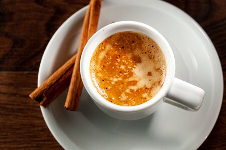 cup of coffee with cinnamon sticks. Top view and close-upの写真素材
