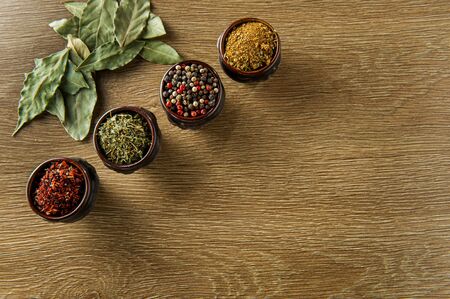 bay leaf, pepper and spice on wooden background top view. Copy spaceの写真素材