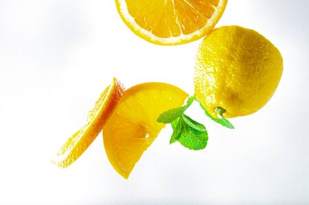 lemon, orange and mint on a light background top view and close upの写真素材