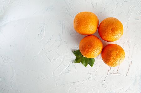 whole oranges on a white background with green leaves, top viewの写真素材