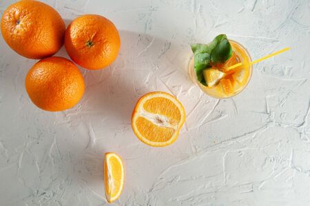 Fresh lemonade with mint, orange and ice in glass jar on the white background. Summer cold drink and cocktail. Flatlayの写真素材