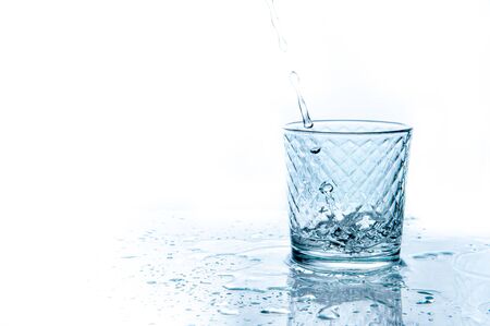 water splashing from glass isolated on white backgroundの写真素材