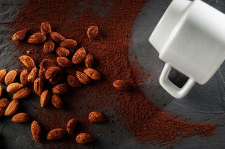 cocoa beans with a cup on a dark gray background. Top viewの写真素材