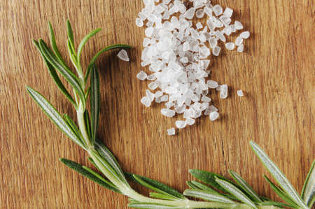 rosemary with salt on the wooden table close up and top viewの写真素材