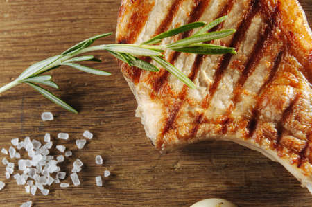 macro shooting steak with salt and baking and garlic on a wooden table. Top view and flat layの写真素材